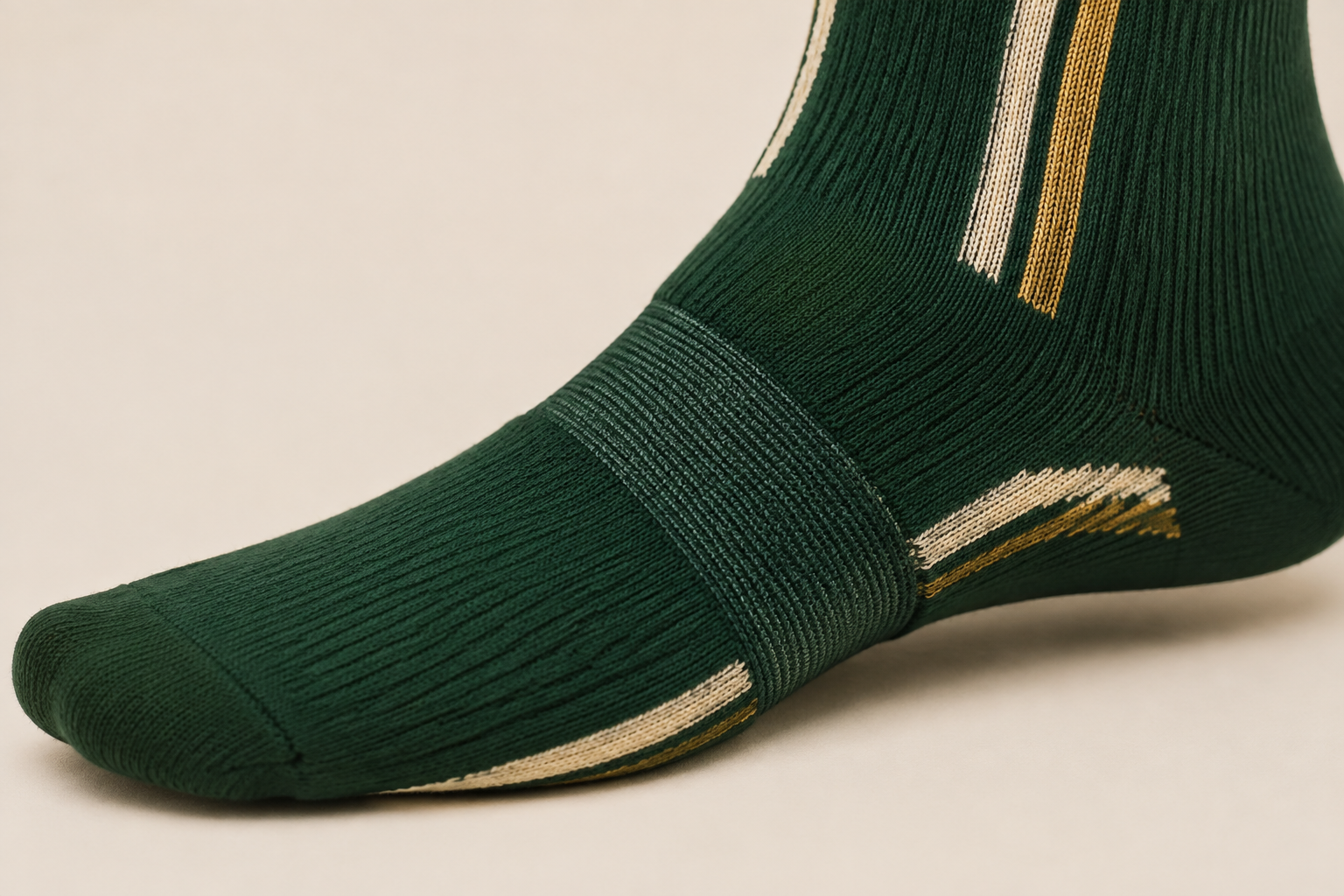 Elasticated arch-support band wrapping the midfoot of a softball sock