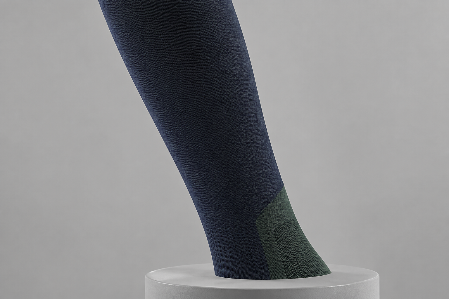 Illustrative low-bulk leg-panel detail on a riding sock