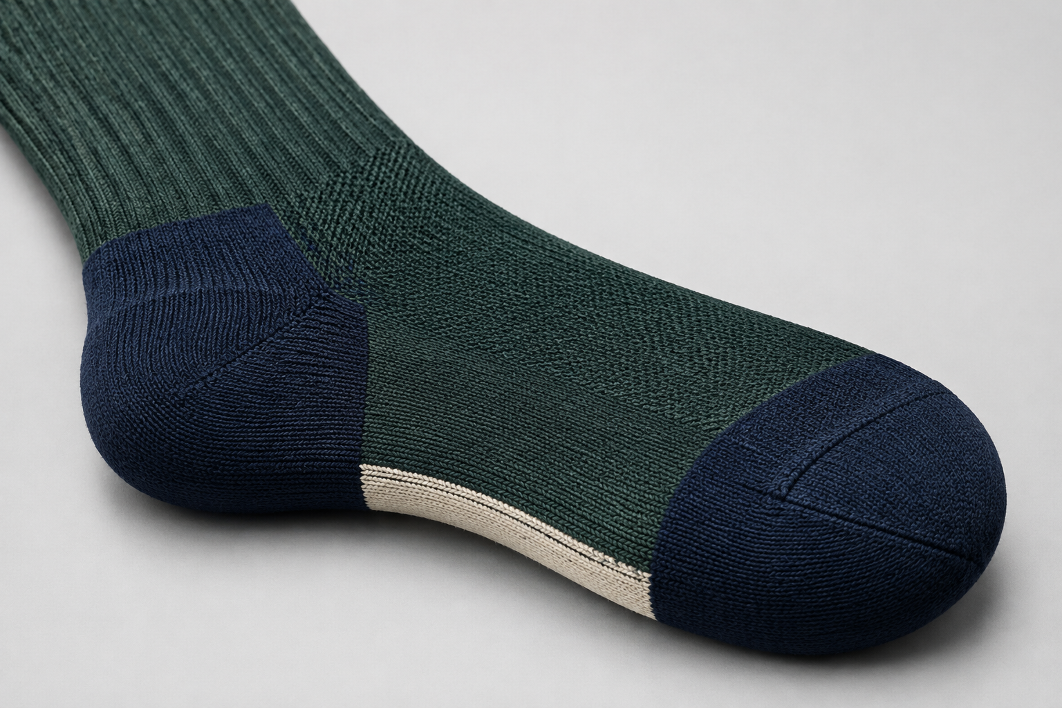 Illustrative reinforced heel and toe direction on a riding sock