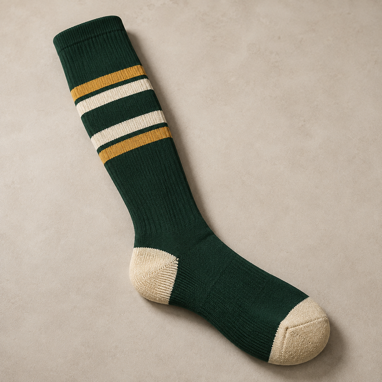 Contrasting reinforced heel and toe panels on a knee-high softball sock
