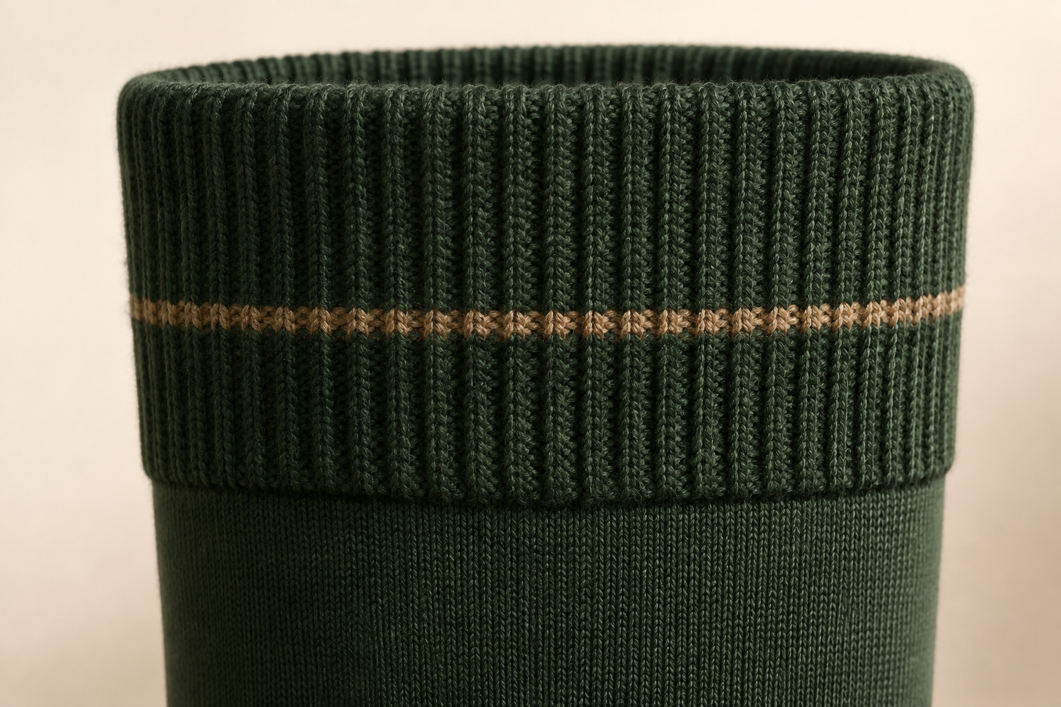 Illustrative ribbed stay-up cuff detail on a riding sock