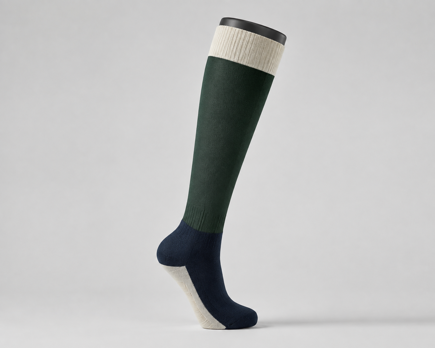 Illustrative full riding sock with a low-bulk leg panel